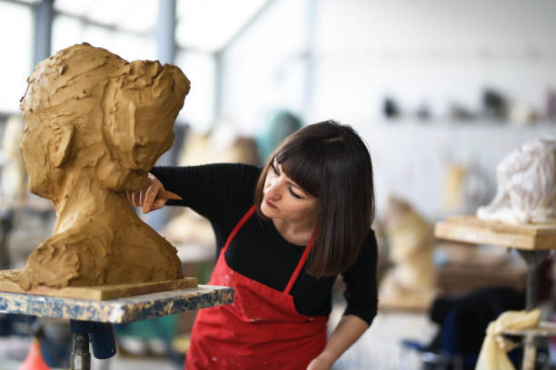 istock Young Female Sculptor is working in her studio 960074012
