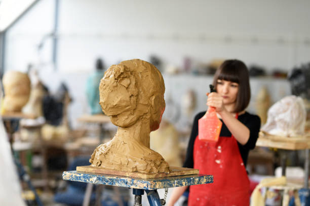 istock Young Female Sculptor is working in her studio 960074058