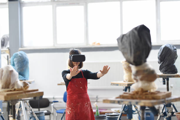istock Young Female Sculptor is working with VR in her studio 960074376