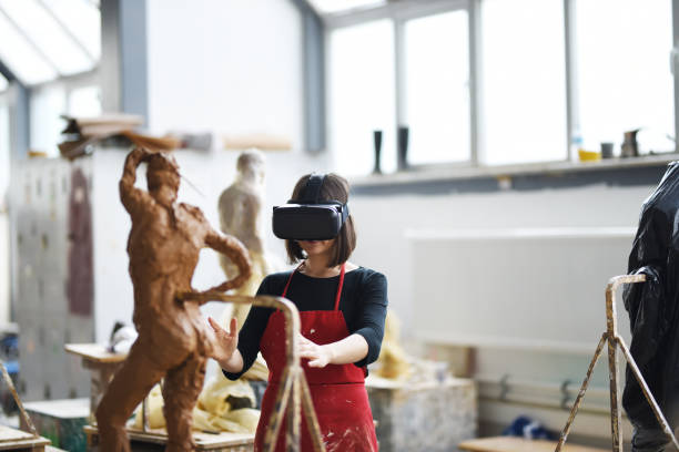 istock Young Female Sculptor is working with VR in her studio 960074524