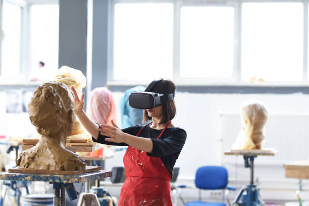 Young Female Sculptor is working with VR in her studio
