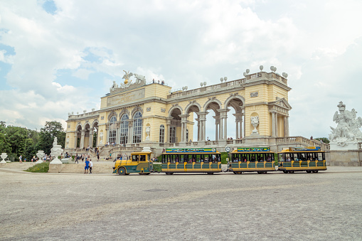 Vienna Austria May.10 2018, Schonbrunn garden with the Gloriette pavilion, tourist riding in panorama train