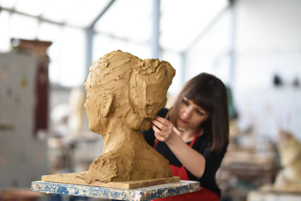 istock Young Female Sculptor is working in her studio 960077912