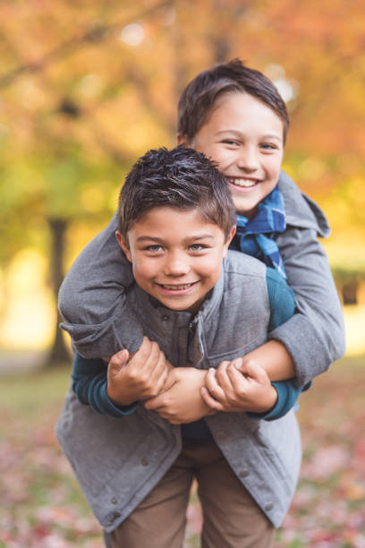 istock Two elementary-age boys walk to school through the park 960086332