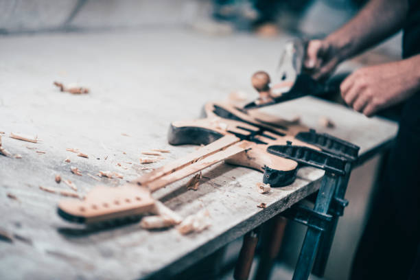 istock Guitar Luthier Polishing His Newest Unfinished Work 960090246