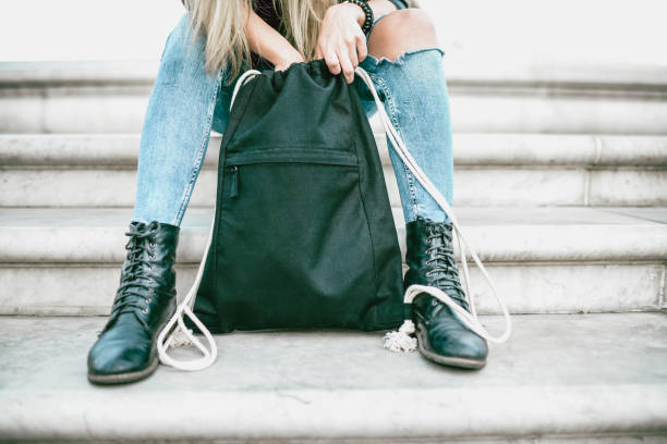 Female Teenager Student Searching Through Backpack