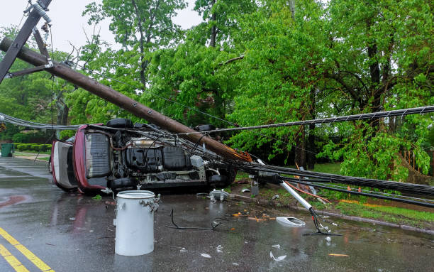 istock Electricity poles fall because of storms. damaged car 960097884