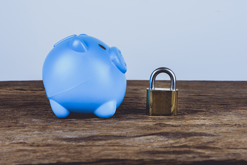 A blue piggybank and lock. Save Money Concept and used for financial protection inferences or other investment messages