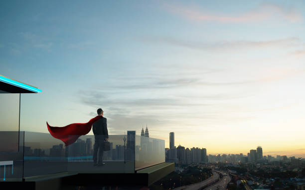 istock Businessman in suit and cape hero stand at open balcony 960108356