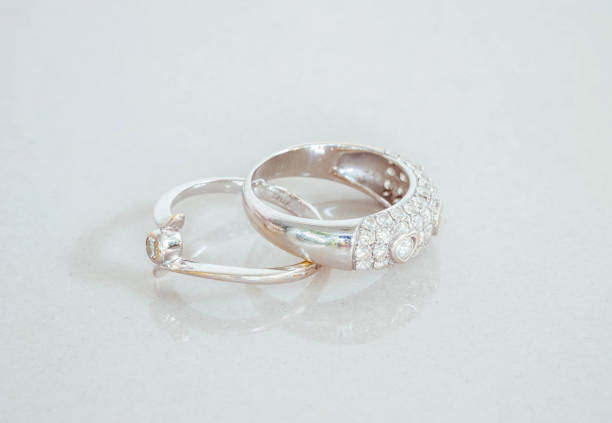 istock Closeup old diamond rings on blurred marble stone floor background 960112140