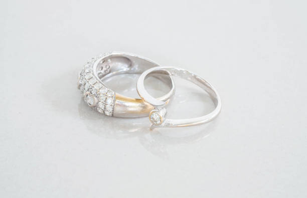 istock Closeup old diamond rings on blurred marble stone floor background 960112148