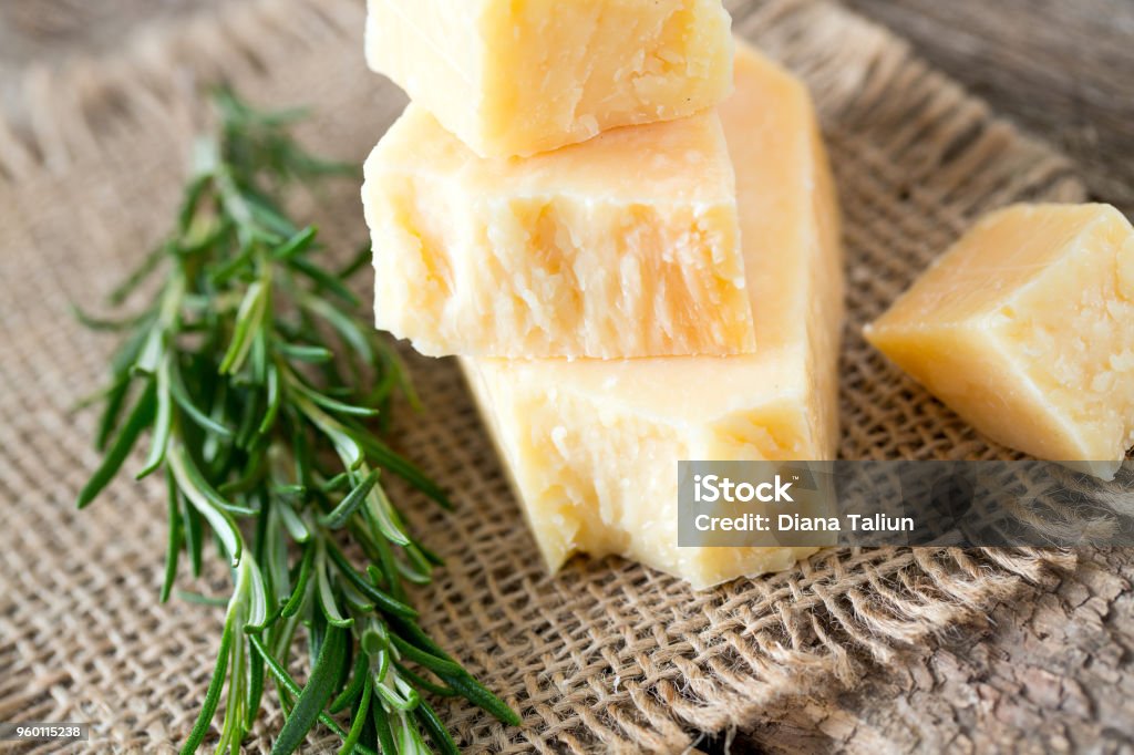 parmesan cheese on wooden surface Parmesan Cheese Stock Photo