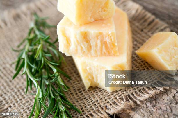 Parmesan Cheese On Wooden Surface Stock Photo - Download Image Now - Parmesan Cheese, Cheese, Rosemary