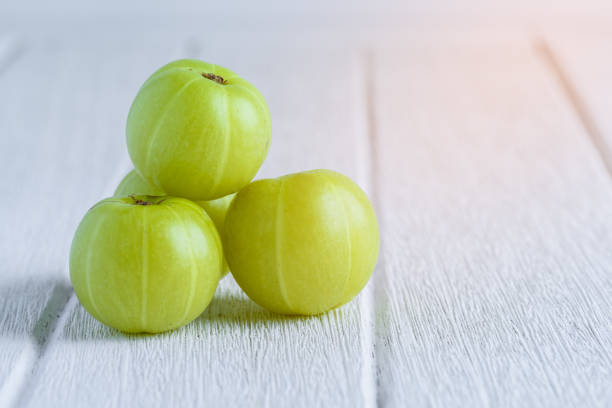 Indian gooseberry on white wooden table