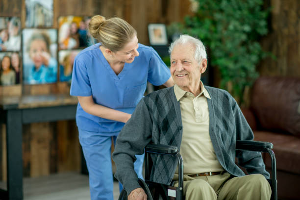istock Pushing Man In Wheelchair 960120384