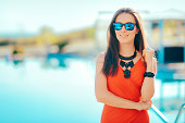 Trendy Woman Wearing Statement Necklace and Sunglasses by the Pool