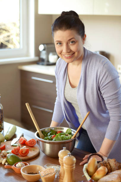 istock woman cooking in the kitchen 960125080