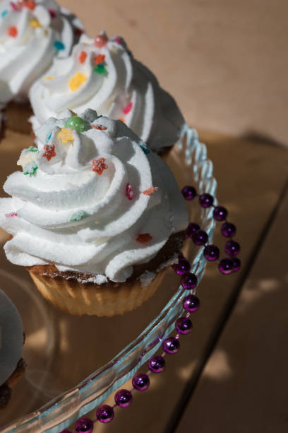 istock Cakes with white cream and colored powder on a glass stand 960125374