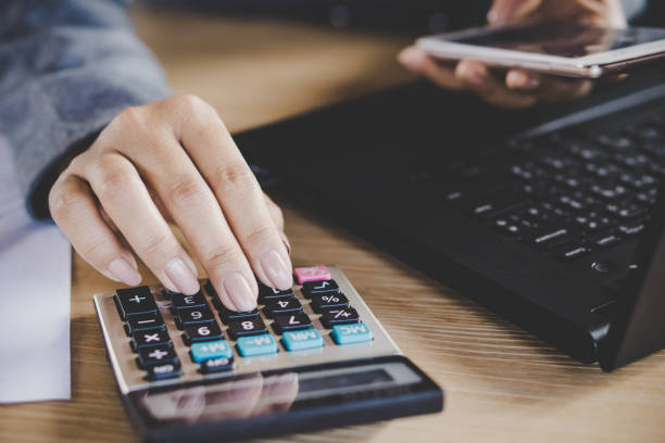 istock businesswoman hand calculating while working on computer laptop 960126734