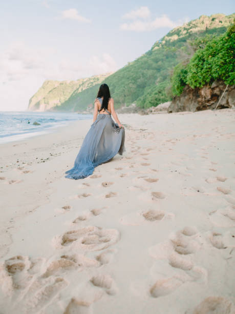 istock Brunette bride in blue wedding dress at beach in Bali 960130308