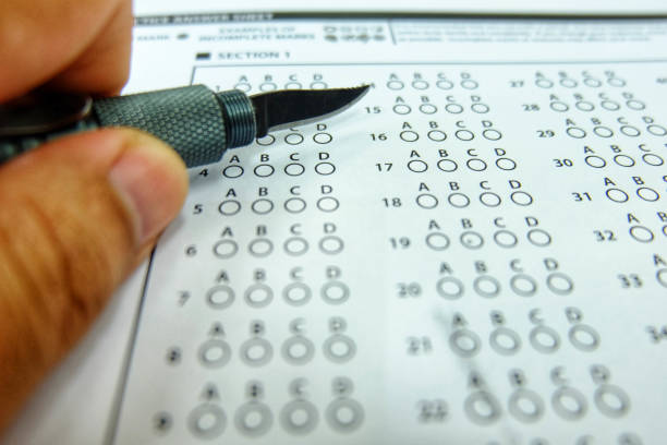 istock The left hand holds the pen knife to selected choice on answer sheets 960140264