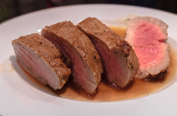 istock medium rare roasted pork fillet with a wine and balsamico sauce. 960140648