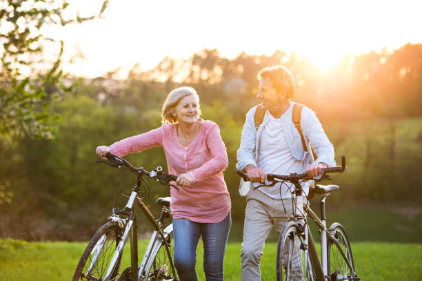 istock Beautiful senior couple with bicycles outside in spring nature. 960144704