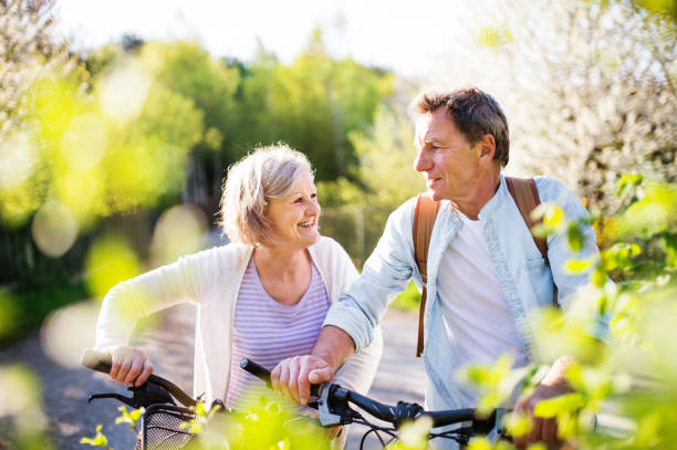 istock Beautiful senior couple with bicycles outside in spring nature. 960144828