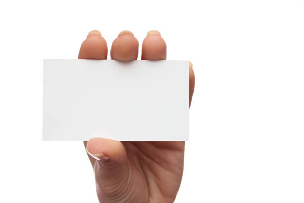 istock Female hand holds business card on white background 960144860