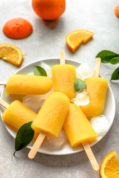 istock Orange popsicles with ice and juice, summer refreshing food 960146084