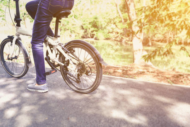 istock woman cyclist riding bicycles in park 960148402