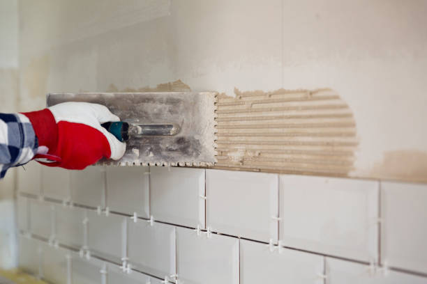 istock Process of tiling the tiles in the kitchen with necessary tiling tools. Home improvement, renovation concept 960148940