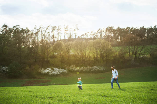 istock A father with his toddler son on a walk outside in spring nature. 960149676