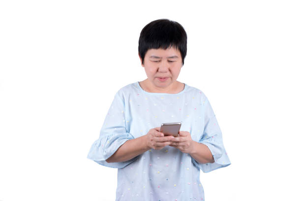 istock Asian Middle-aged woman using mobile phone isolated on white background 960149808