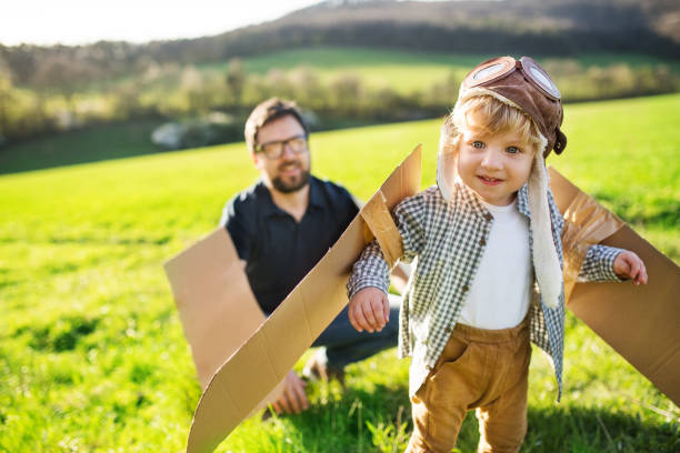 istock Happy toddler boy playing outside with father in spring nature. 960149848