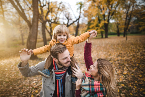istock Happy parents having fun with their small son in autumn day. 960150534