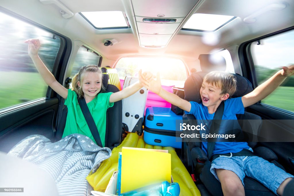 Children relax in the car during a long car journey Holidays - Children relax in the car during a long car journey Car Stock Photo