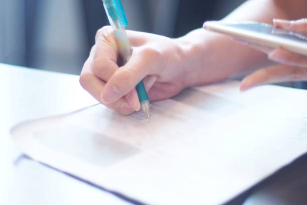 istock Young woman fills in the document 960159222