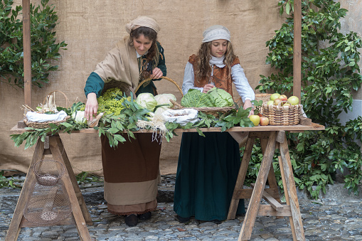 Taggia, Italy - March 18, 2018: Participants of medieval costume party in the historic city of Taggia in Liguria region of Italy. The actors acting out episodes of daily life in settings that evoke moments of life lived fully the seventeenth century. The episodes depicted are inspired by true events, drawn from documents preserved in the Historical Archives