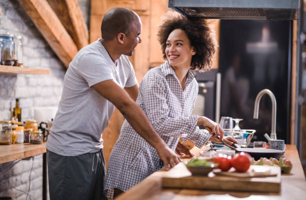 istock Happy black couple talking while preparing breakfast in the kitchen. 960161212