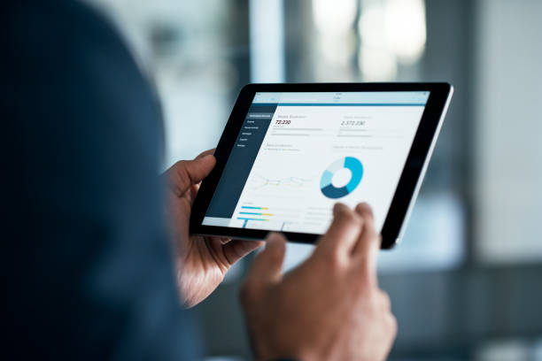 The stats have a lot to say Closeup shot of a businessman analyzing statistics on a digital tablet in an office digital tablet stock pictures, royalty-free photos & images