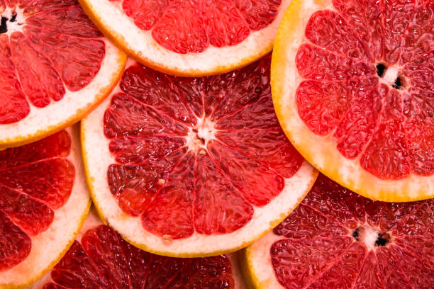 istock Sliced grapefruits, background, natural texture of citrus, top view, close-up 960165070