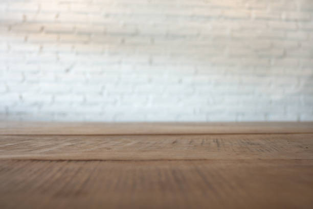 istock Vintage wooden table with white brick background in the room 960166876