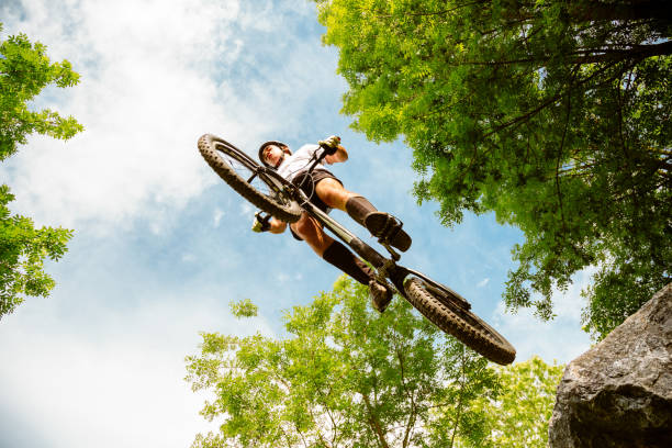 Cyclist extreme jumping from a rock