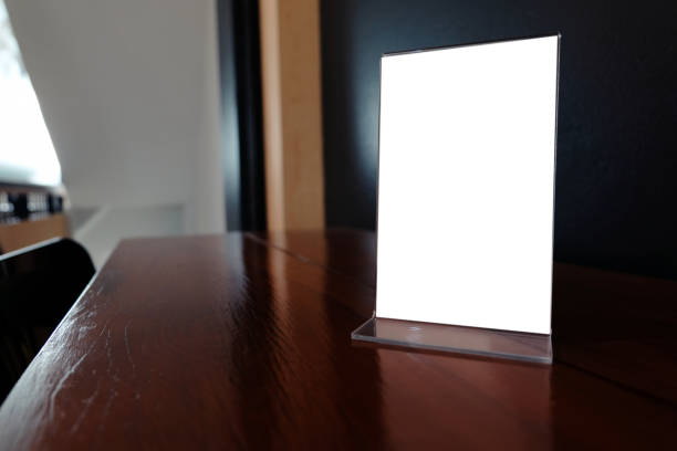 istock Mock up Menu frame standing on wood table in Bar restaurant cafe. space for text 960171166