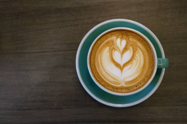 istock Cup of hot latte art coffee on wooden table 960171306