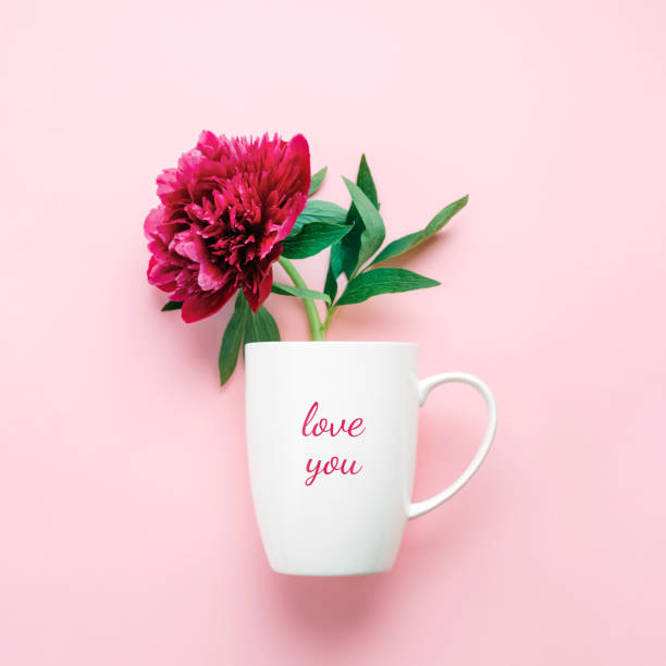 istock A cup with text Love You and pink flower. 960172674