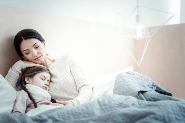 istock Sick girl sleeping near her mother 960176916