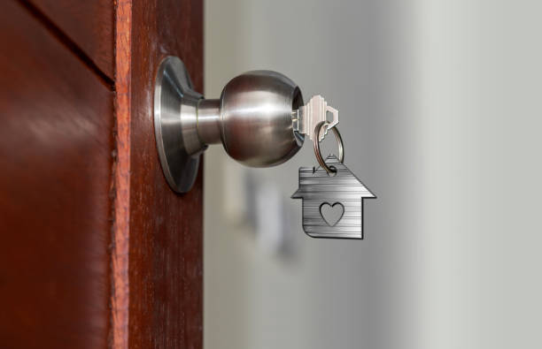 istock Open door with keys, House key in keyhole with small house 960177466