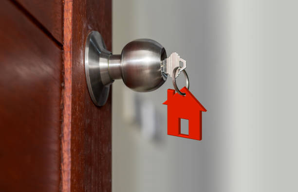 istock Open door with keys, House key in keyhole with small house 960177468